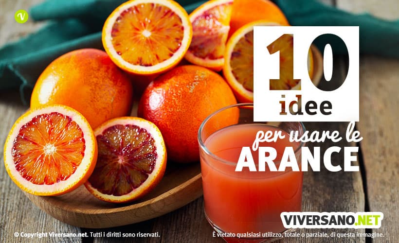 Arance tagliate e bicchiere con succo di arancia